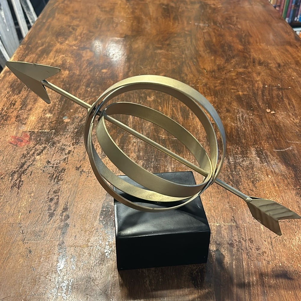 Gold armillary sphere with arrow decor